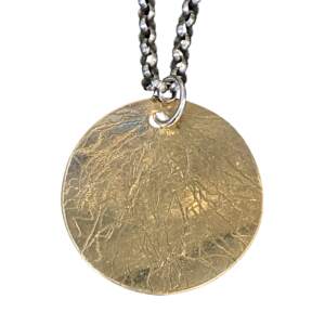 Round textured shiny bronze pendant on a sterling silver chain by Karyn Chopik.