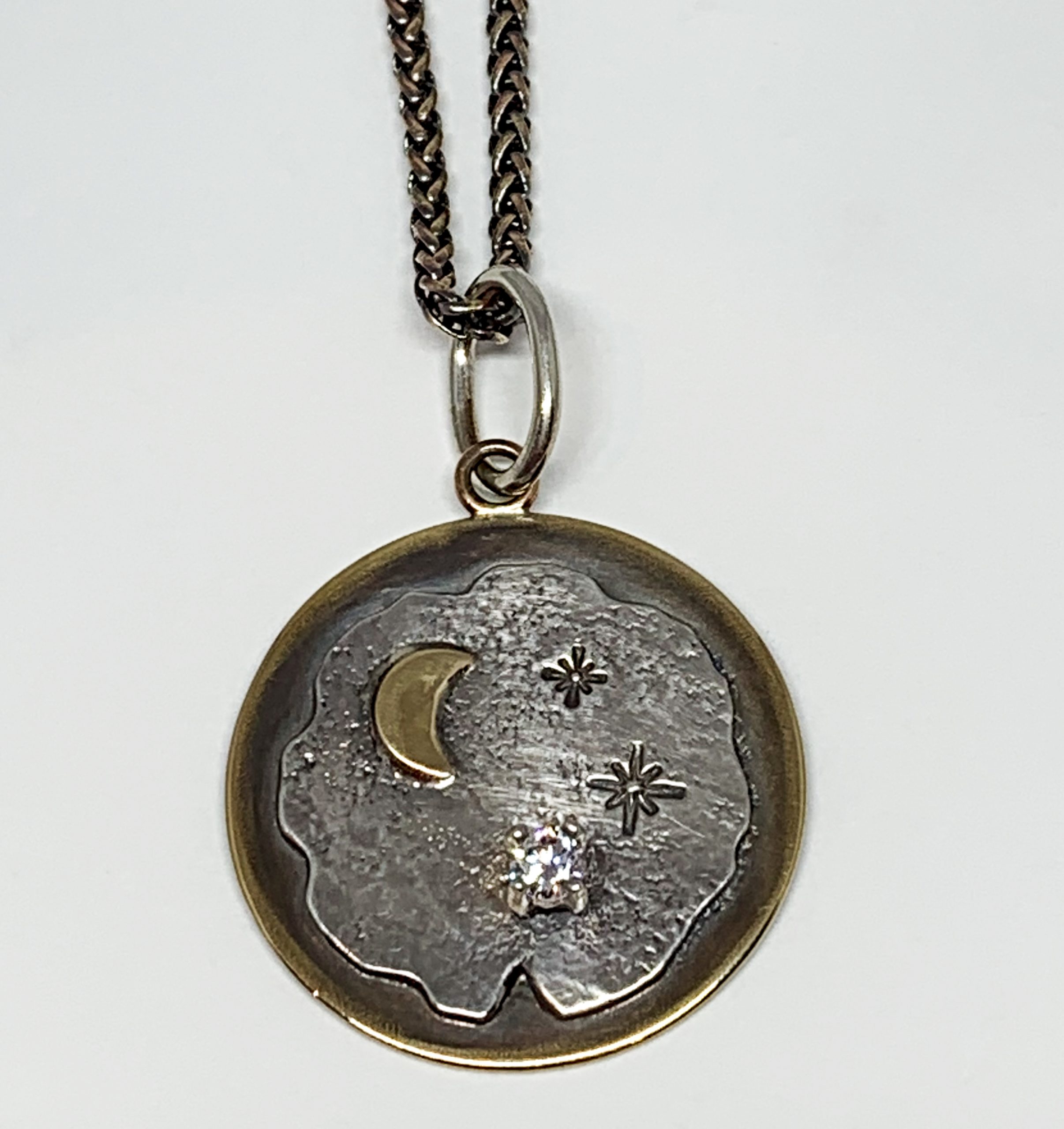 Bronze, sterling silver, and CZ night sky pendant by Karyn Chopik | Effusion Art Gallery + Cast Glass Studio, Invermere BC