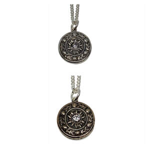 Reversible bronze and sterling silver sundial pendant with a CZ in the centre on a sterling silver chain by Karyn Chopik.
