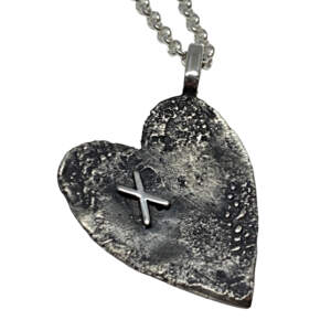 Oxidized sterling silver heart pendant with textured dots and X by Karyn Chopik.