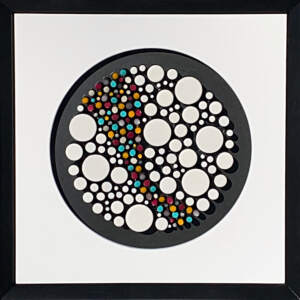 Wood and enamel mosaic with a colorful river flowing through white dots on a black background with a white mat and black frame.