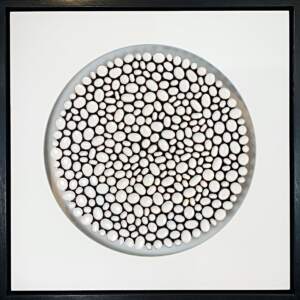 Organic white, copper, and enamel mosaic with a white mat and black frame.