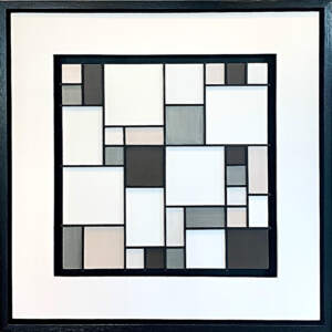 Graphic neutral mixed media mosaic with a white mat and black frame.