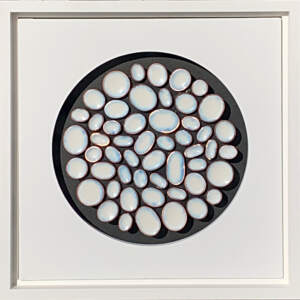White, copper, and enamel mosaic on a black background with white mat and frame.