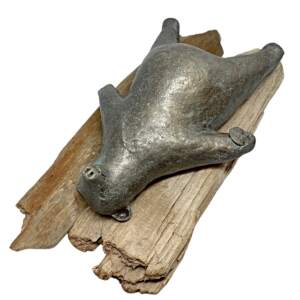 Mixed media sculpture by Karin Taylor of a friendly bear laying on his back in the savasana pose on a driftwood yoga mat with a sand dollar in his right hand.