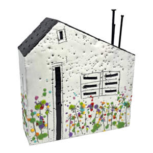 3-D encaustic white house with a black roof and multicoloured wildflowers by Brenda Walker.