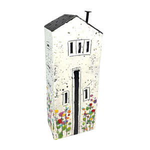 3-D encaustic white house with a black roof and multicoloured wildflowers by Brenda Walker.
