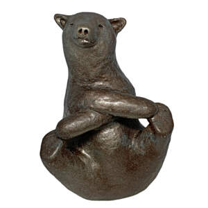 Mixed media sculpture of a bear in the yoga crossover boat pose by Karin Taylor.