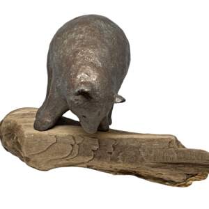 Mixed media bear sculpture of a playful bear foraging on driftwood by Karin Taylor.