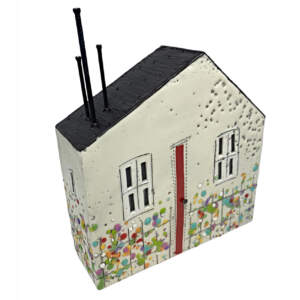 Original encaustic painting of a 3-D cream house with a red door and black roof with abstract flowers by Brenda Walker.