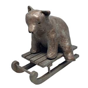 Original mixed media sculpture of a cute bear on a sled by Karin Taylor.
