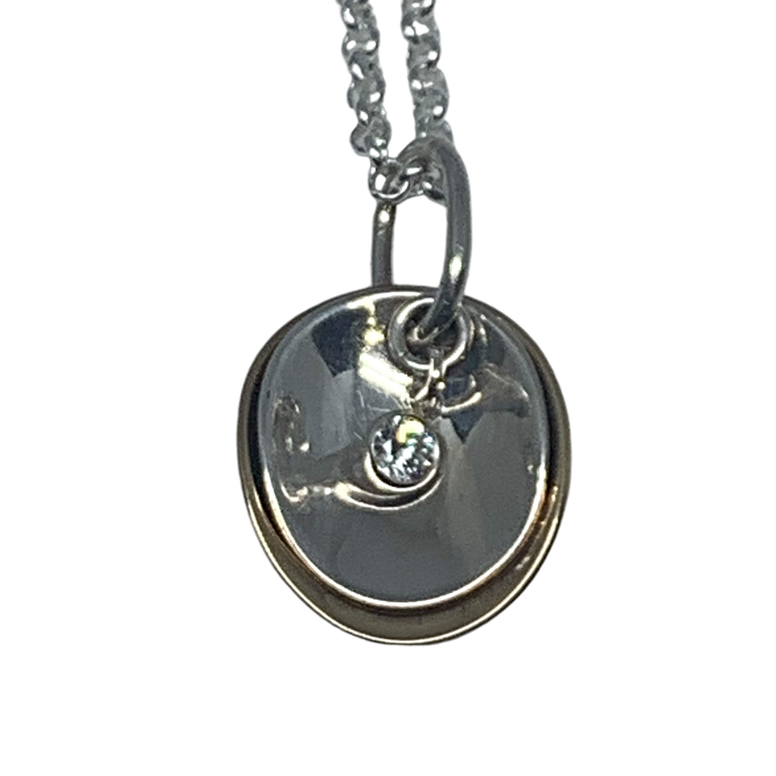 Layered sterling silver, bronze + CZ pendant by Karyn Chopik at Effusion Art Gallery in Invermere, BC.