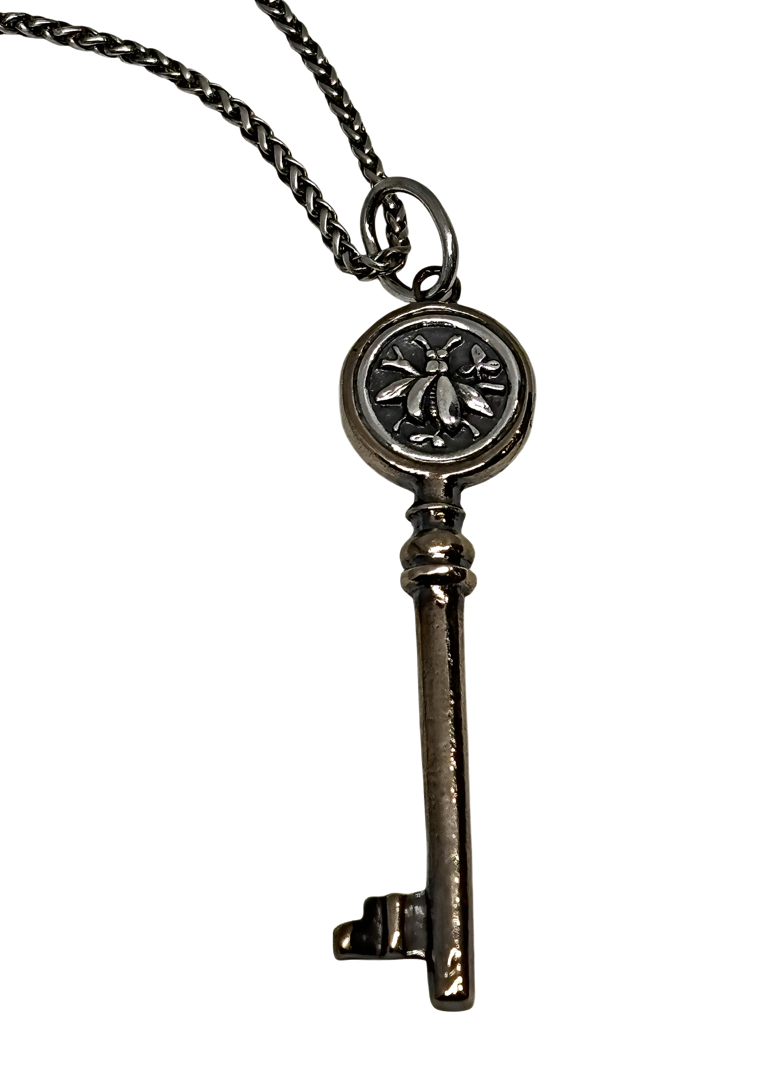 Handmade bronze and sterling silver bee key pendant by Karyn Chopik Jewelry at Effusion Art Gallery in Invermere, BC.