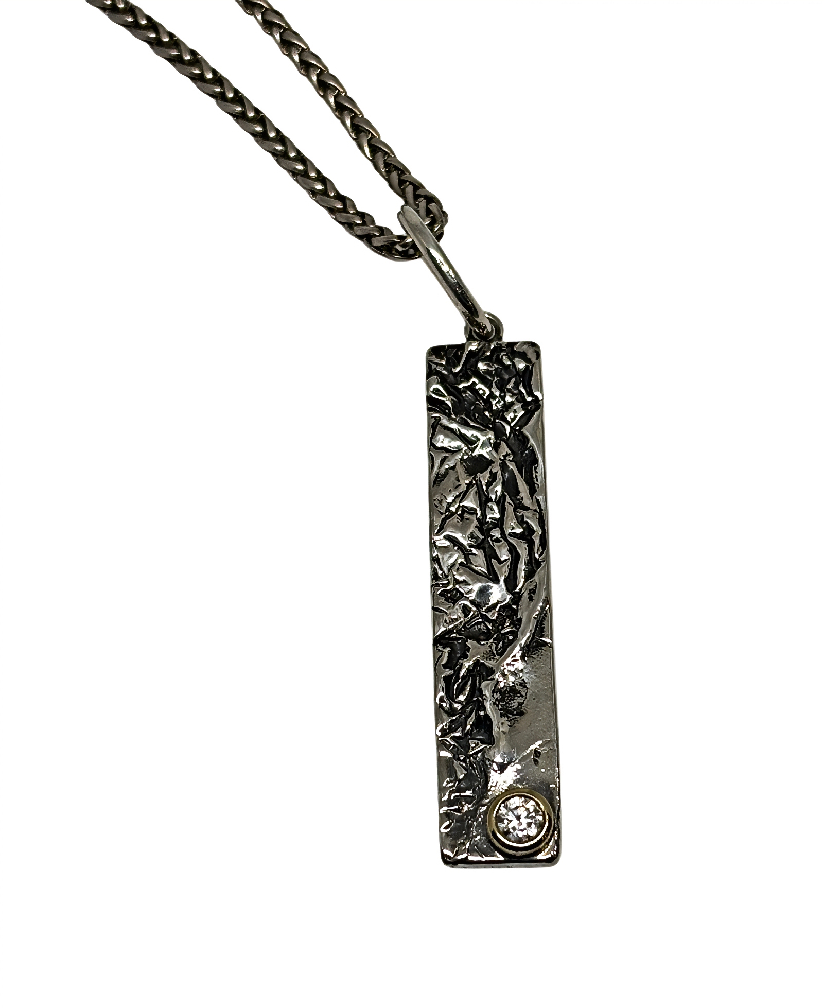 Handmade sterling silver, bronze, and cubic zirconia pendant by Karyn Chopik Jewelry at Effusion Art Gallery in Invermere, BC.