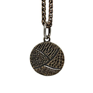 Handmade bronze + sterling silver pendant by Karyn Chopik Jewelry at Effusion Art Gallery in Invermere, BC.