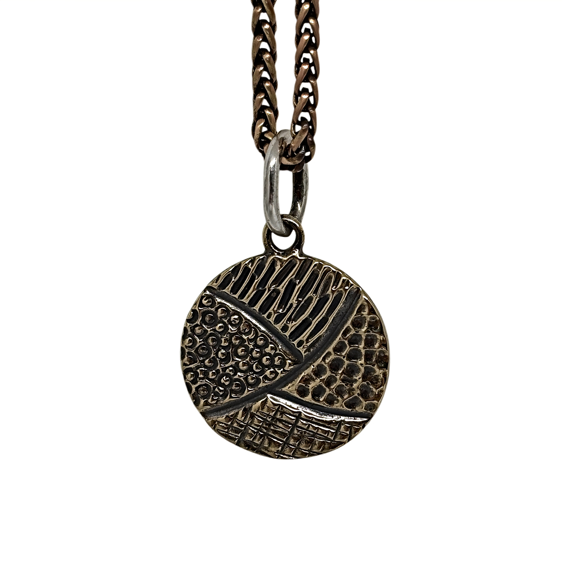 Handmade bronze + sterling silver pendant by Karyn Chopik Jewelry at Effusion Art Gallery in Invermere, BC.