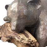 Nap Attack Cub, original mixed media sculpture of a cute bear cub napping on a piece of driftwood by Canadian artist Karin Taylor at Effusion Art Gallery in Invermere, BC.